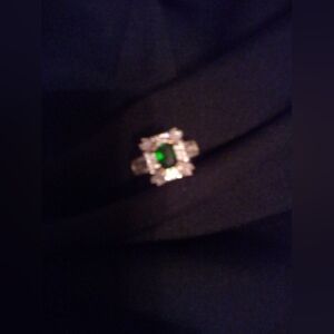 Med size green stone surrounded by cz diamonds ring sz 10